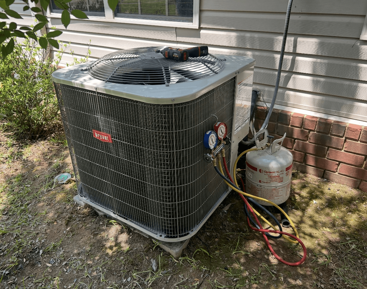 Bryant outdoor unit during HVAC service with gauges attached
